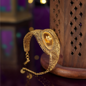 22KT Turkish design yellow gold bracelet with a beaded oval centre, small flower and hexagon cut-out band.