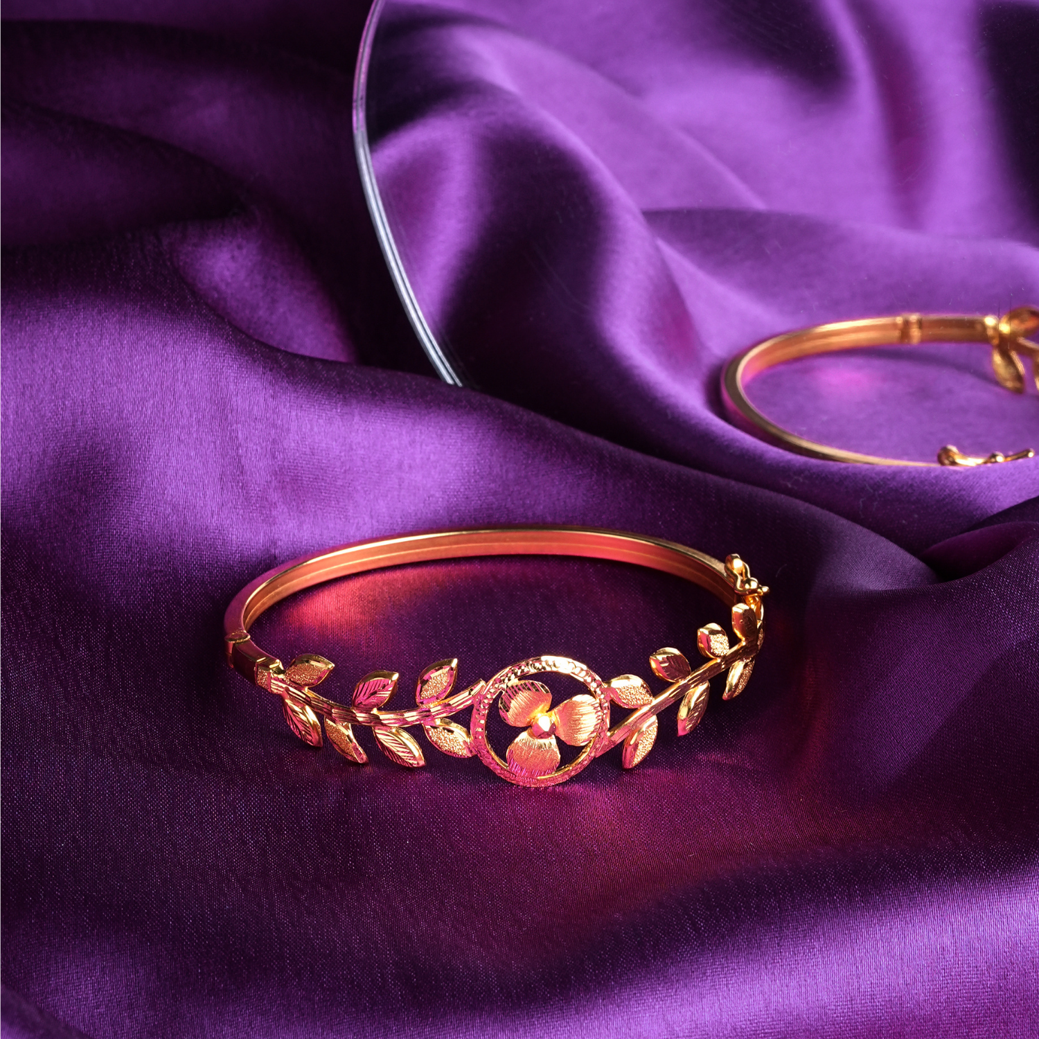 Eternal Bloom 18kt gold bracelet by Taqwa Jewellers with detailed floral centrepiece and polished gold finish.