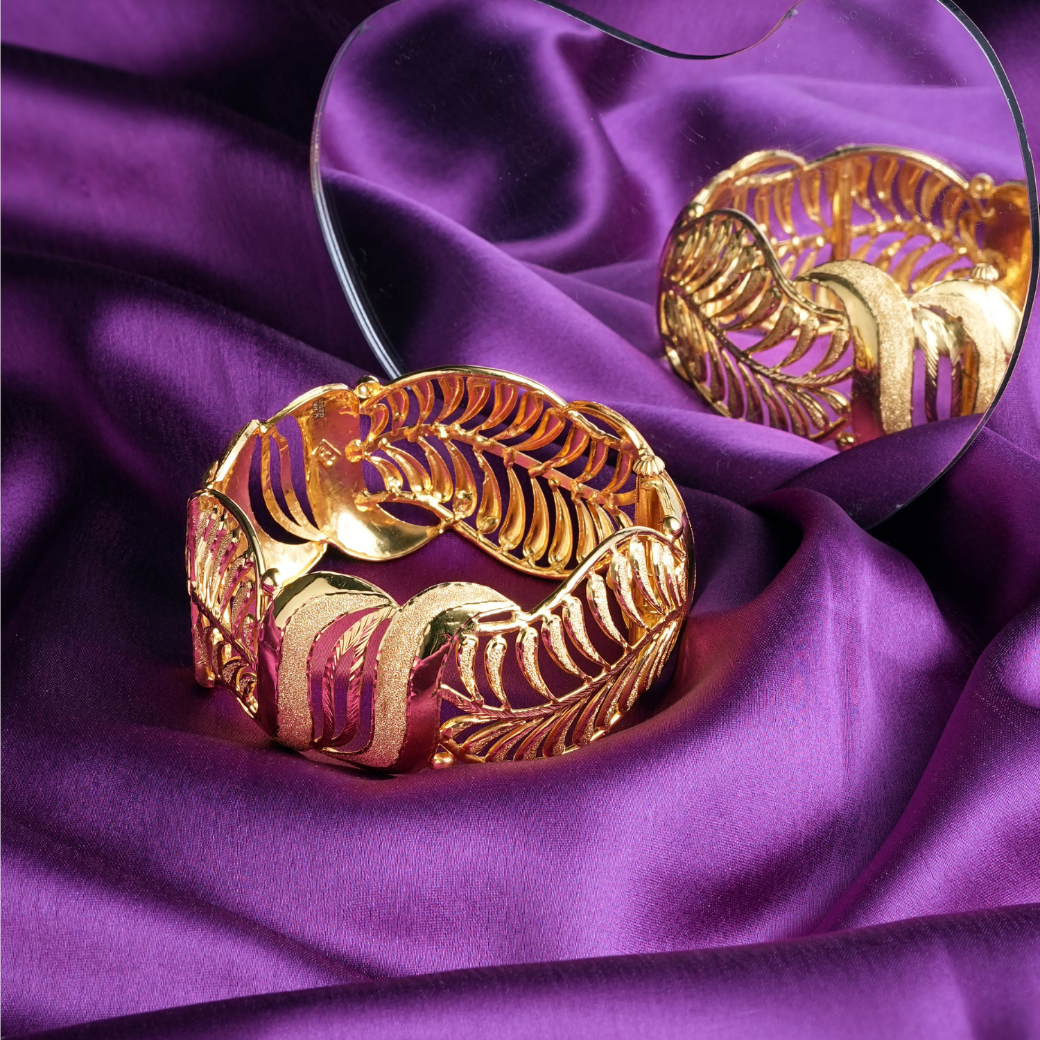 Ethereal Leaf 18kt gold bracelet by Taqwa Jewellers with intricate leaf-inspired openwork and textured gold detailing.