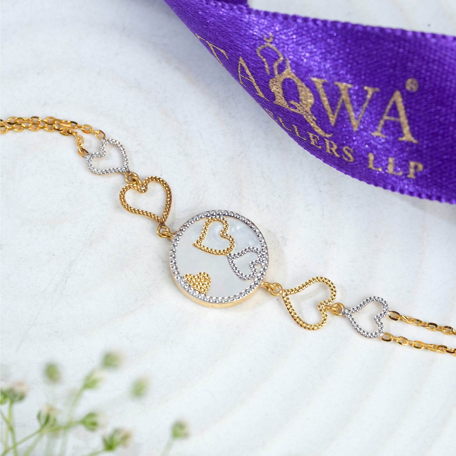 Qalbeen 18kt gold bracelet by Taqwa Jewellers with a heart-motif medallion and stone-lined heart-shaped chain links.