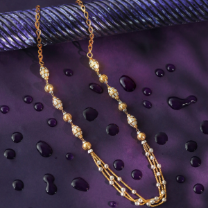 Garland 18kt gold chain with striped oval beads, round gold beads and three fine strands.