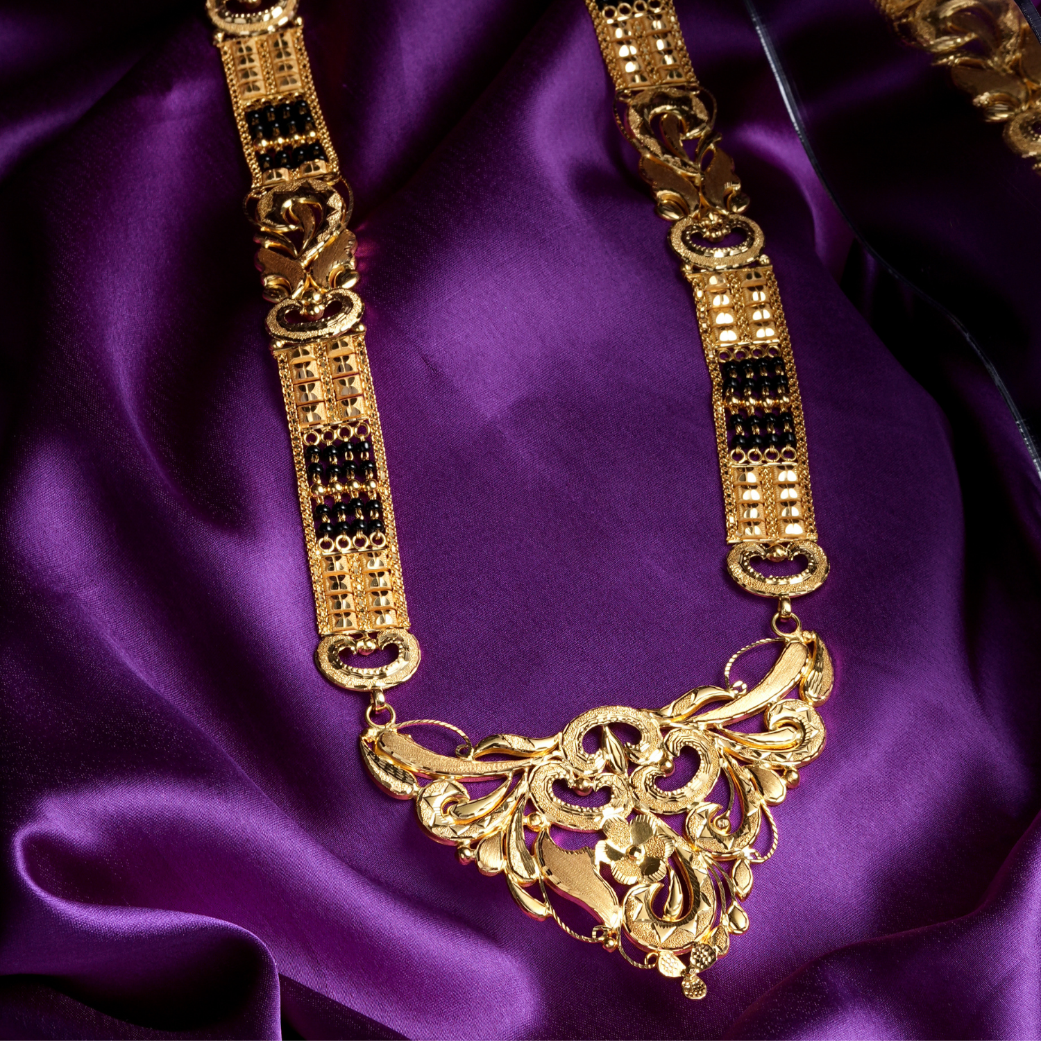 Orlina 18K Gold Mangalsutra with detailed pendant and black-bead chain.