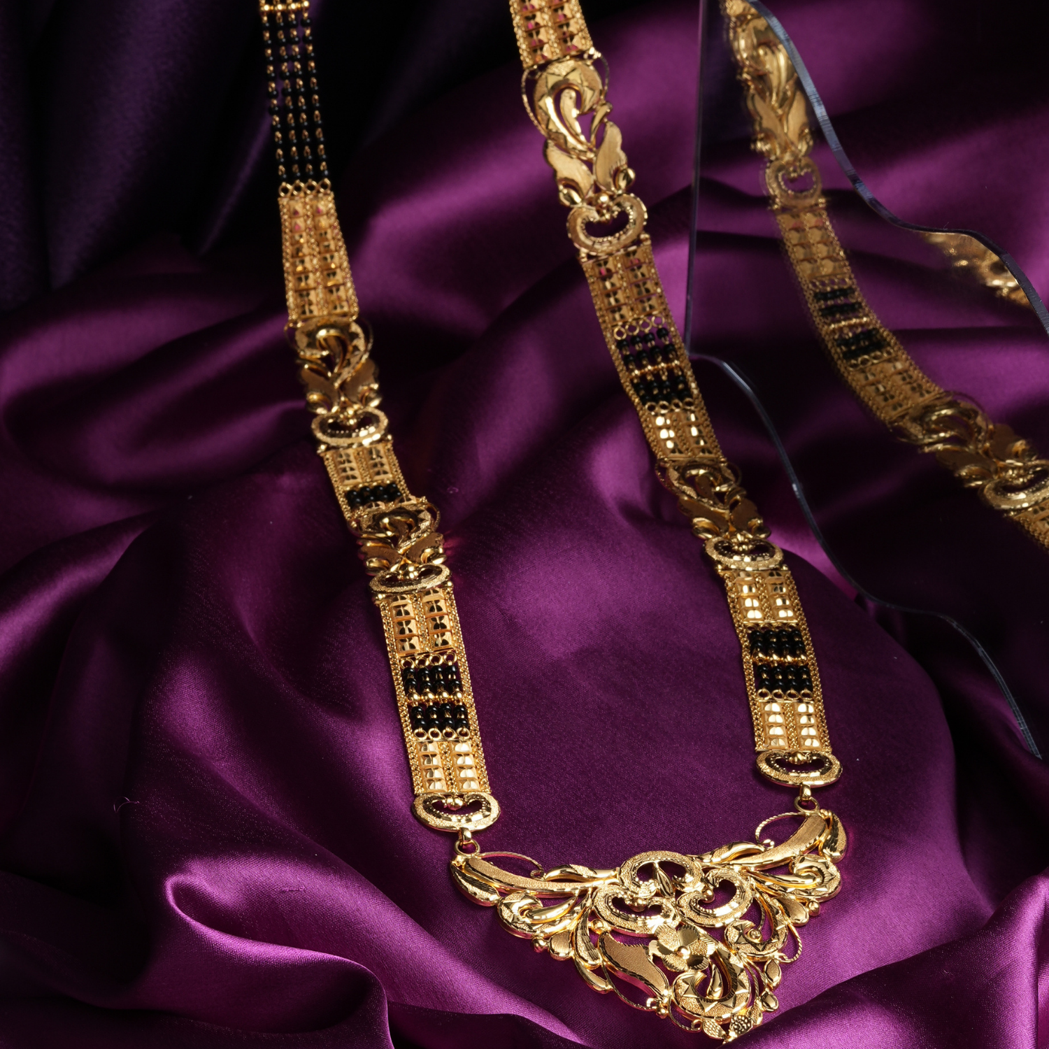 Orlina 18K Gold Mangalsutra with detailed pendant and black-bead chain.