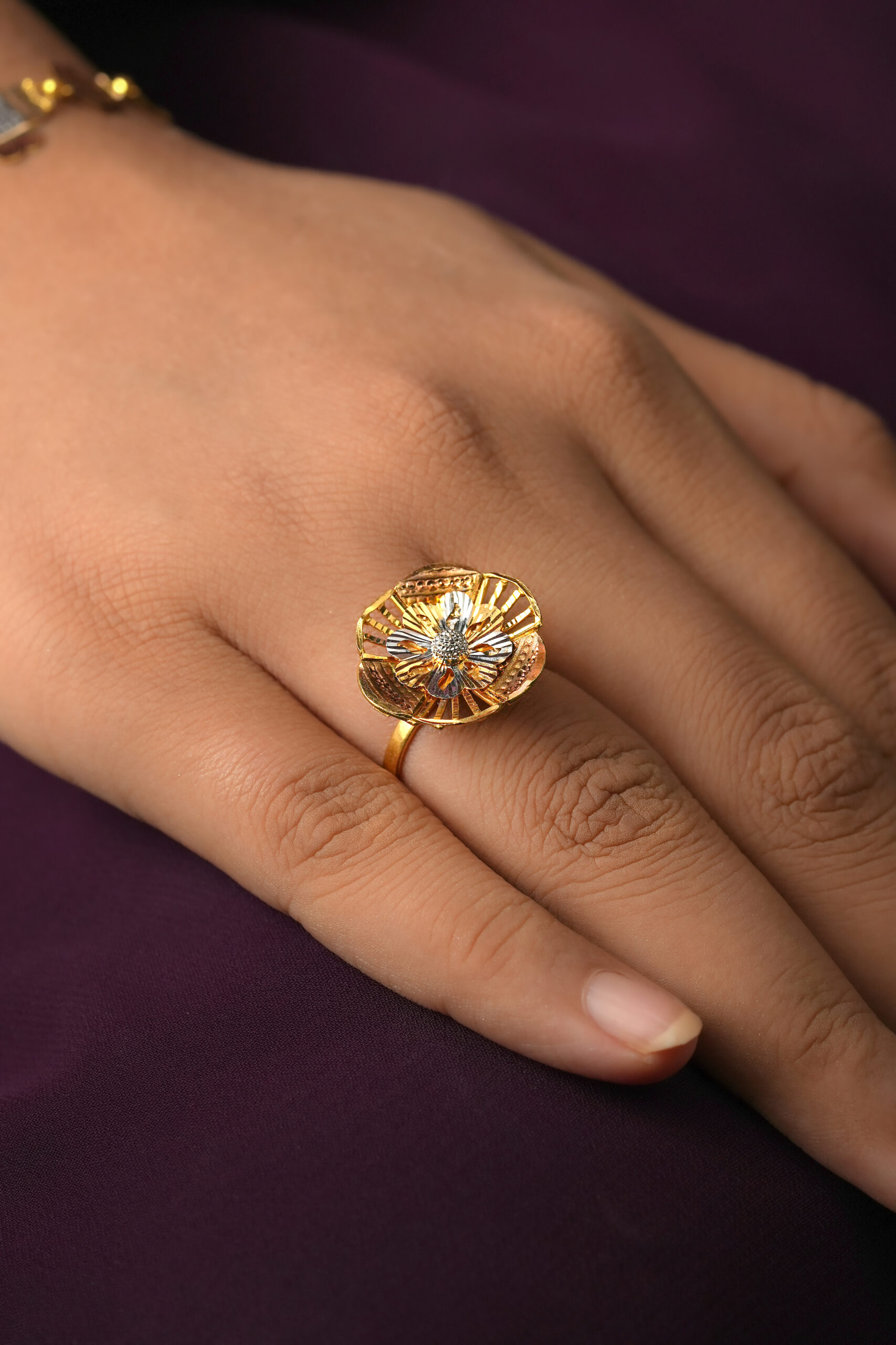 The Wardah Ring is a masterpiece that brings together traditional Islamic artistry and modern elegance. Designed in luxurious 22K yellow gold, the ring features a beautiful flower motif, delicately carved to create a three-dimensional, lifelike bloom. At the center, sparkling white gold accents highlight the intricate detailing, making the flower design truly stand out.