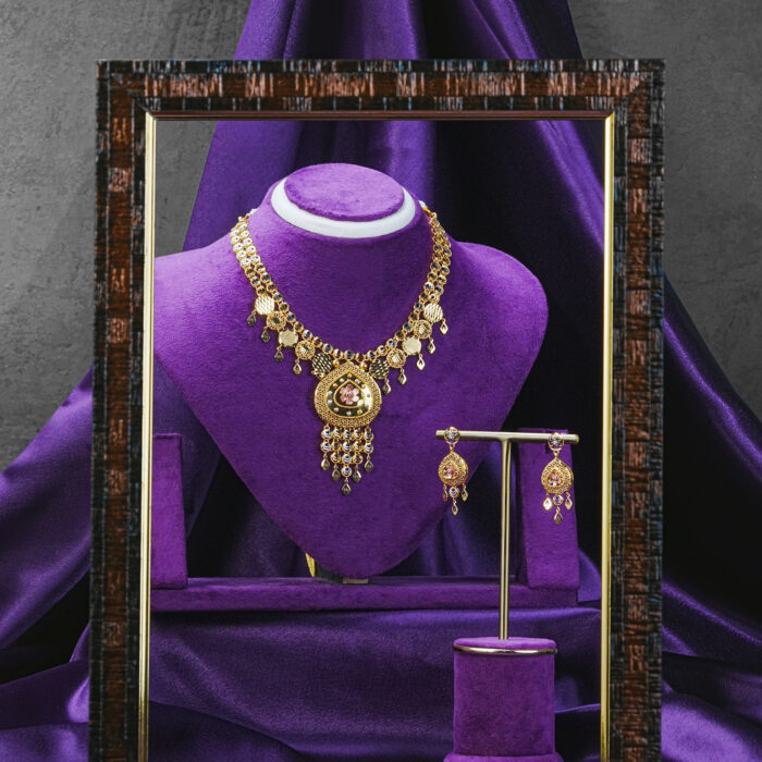 Customization & Weight Material: Real gold, ready in 22kt (customizable in 18kt) Approximate Weight: 50 to 55 grams Availability: Made-to-order to ensure precision and exclusivity How to Style The Noor Filigree Cascade Set is versatile, making it the perfect companion for both traditional and fusion looks: Bridal Chic: Ideal for pre-wedding functions like Mehendi or Sangeet. Style it with Anarkalis, lehengas, or pastel sarees for a romantic bridal touch. Cultural Celebrations: Let it elevate your Eid, Navratri, or festive outfit. It pairs beautifully with silk sarees, salwar suits, and fusion gowns. Modern Fusion: Wear the earrings solo with a crisp white shirt and palazzos or a long kurti and jeans for effortless Indo-western charm. Layered Look: Add a choker or shorter gold chain for a regal layered appearance. More Information Type: Traditional Real Gold Necklace & Earrings Set Material: 22kt gold (customizable in 18kt) Inclusions: 1 Necklace, 1 Pair of Earrings Closure: Adjustable dori (thread) for the necklace, push-back for earrings Craft: Handcrafted filigree design Who It’s Perfect For This set is a celebration of tradition, elegance, and artistry—ideal for: Brides & Bridesmaids seeking timeless elegance with a luxurious gold touch Cultural Enthusiasts who appreciate heritage craftsmanship Modern Women blending ethnic wear with contemporary flair Gift-Givers honoring milestones like weddings, anniversaries, or festivals Collectors building a legacy of fine, handcrafted gold jewelry Care Tips Preserve the glow of your Noor Filigree Cascade Set by following these essential care tips: Keep Dry: Avoid contact with water, perfumes, and chemicals Clean Gently: Use a soft, dry cloth to wipe the jewelry after each use Store Safely: Place in a velvet box or pouch separately to avoid scratches Avoid Commercial Cleaners: Use only professional gold cleaning services if needed Handle with Care: These handmade pieces deserve thoughtful handling Delicate yet regal, timeless yet modern. Noor Filigree Cascade Set