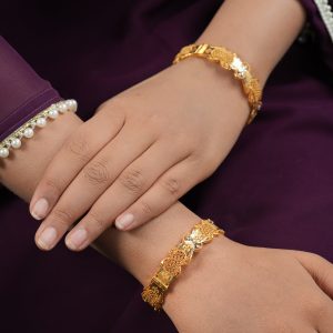 Waveglow 22kt gold bangles by Taqwa Jewellers with mesh and mirror-polished panels and floral engraving.