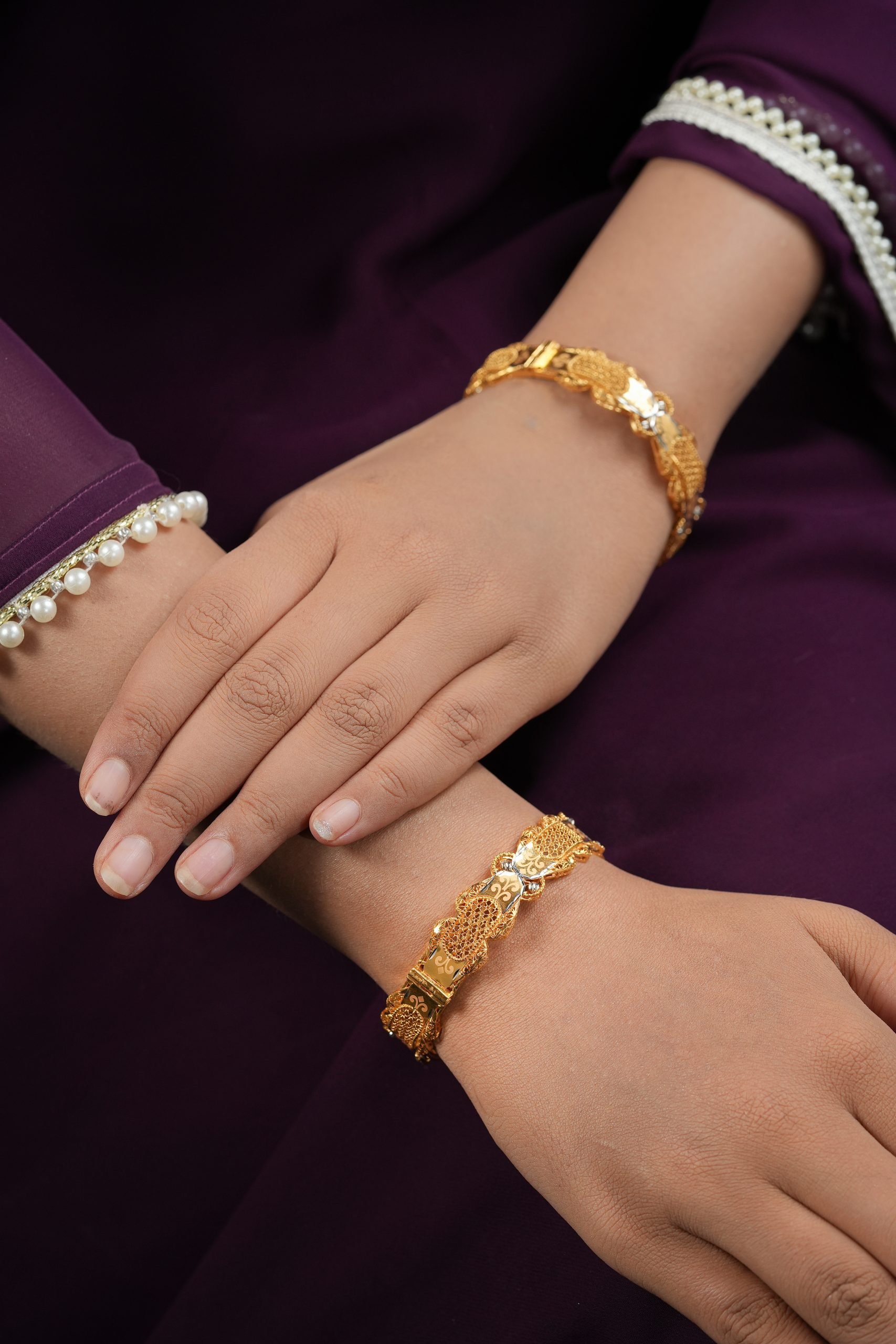 Waveglow 22kt gold bangles by Taqwa Jewellers with mesh and mirror-polished panels and floral engraving.