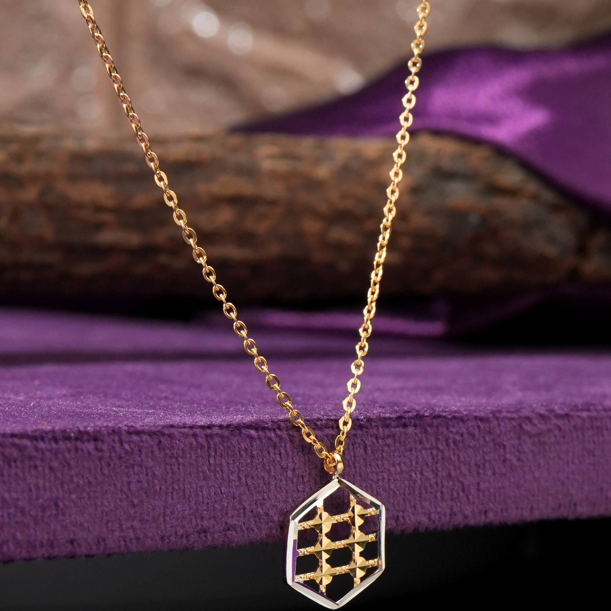Hexa 18KT gold chain with a hexagon pendant, a rhodium frame and a yellow gold box grid, by Taqwa Jewellers.