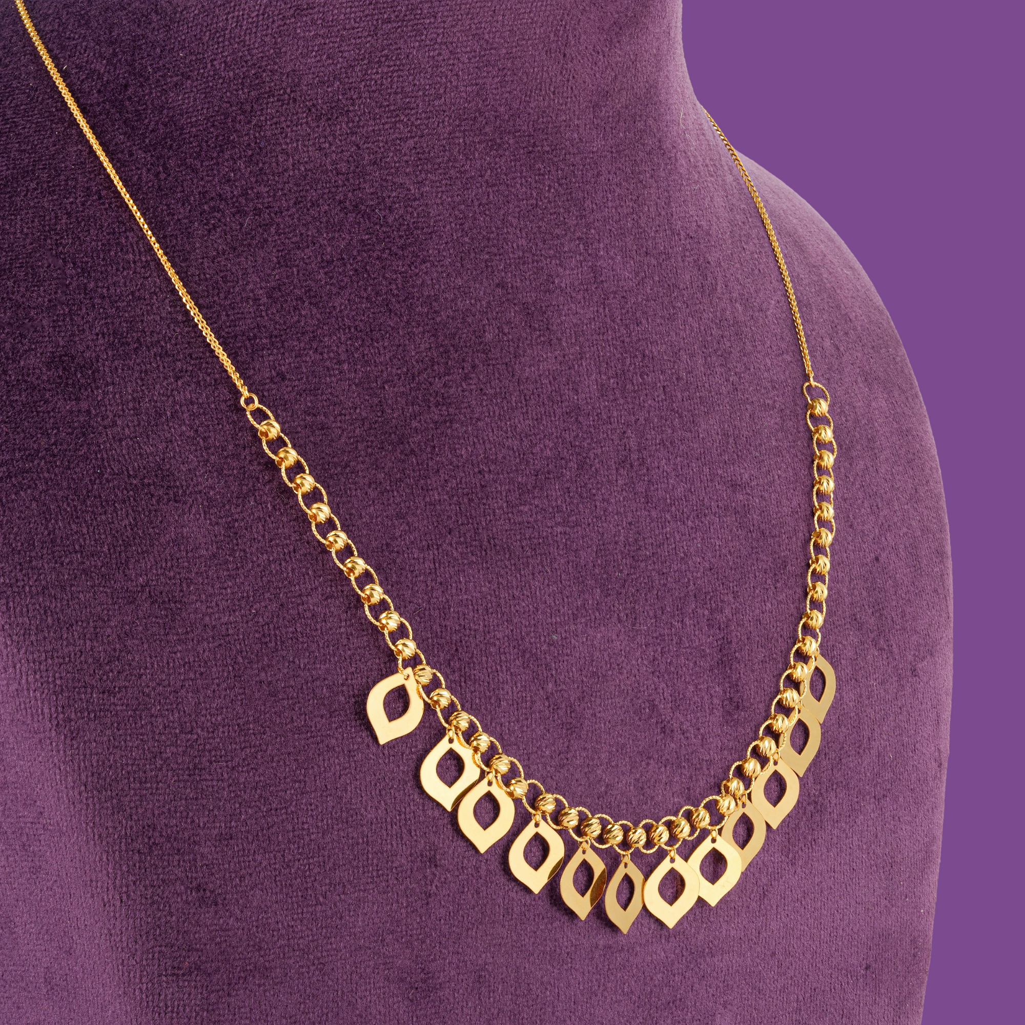 Shop the Dropelle 18KT gold necklace set at Taqwa Jewellers, featuring a matching necklace, bracelet, earrings, and ring in a distinctive drop-inspired design.