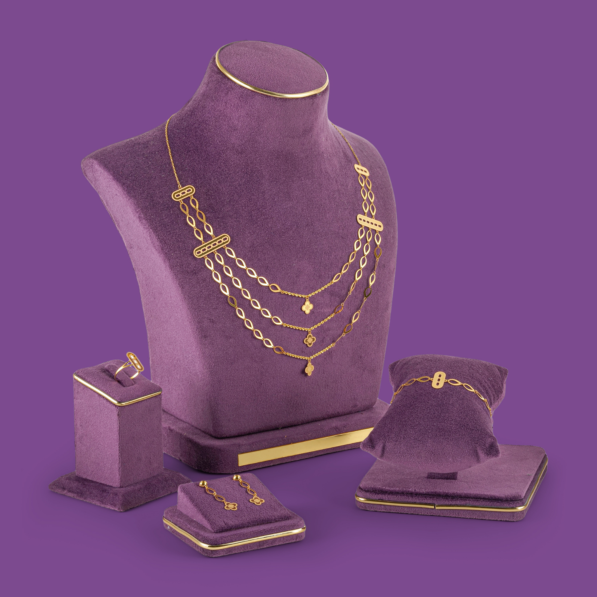 Gleam Gold Necklace Set by Taqwa Jewellers with a three-tier almond-link necklace, bracelet, earrings and ring.