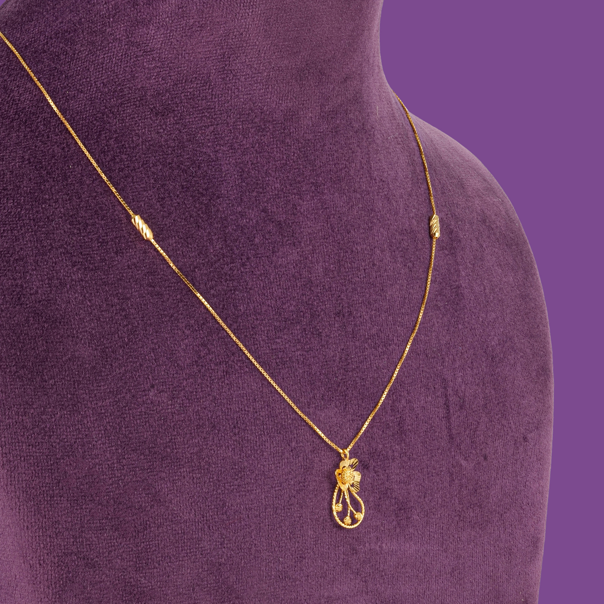 Lily 22KT Gold Chain - a gold box chain with an open-work floral pendant and two slanted-cut beads, by Taqwa Jewellers.