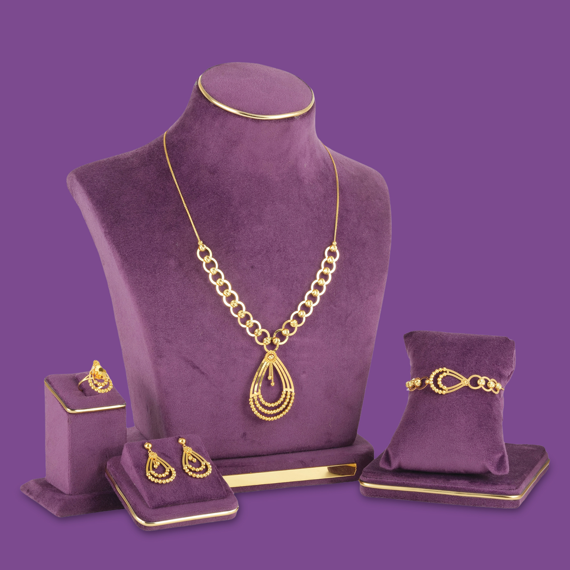 18KT gold necklace set with bracelet, ring and earrings in open rings, teardrop frames and cut gold beads.