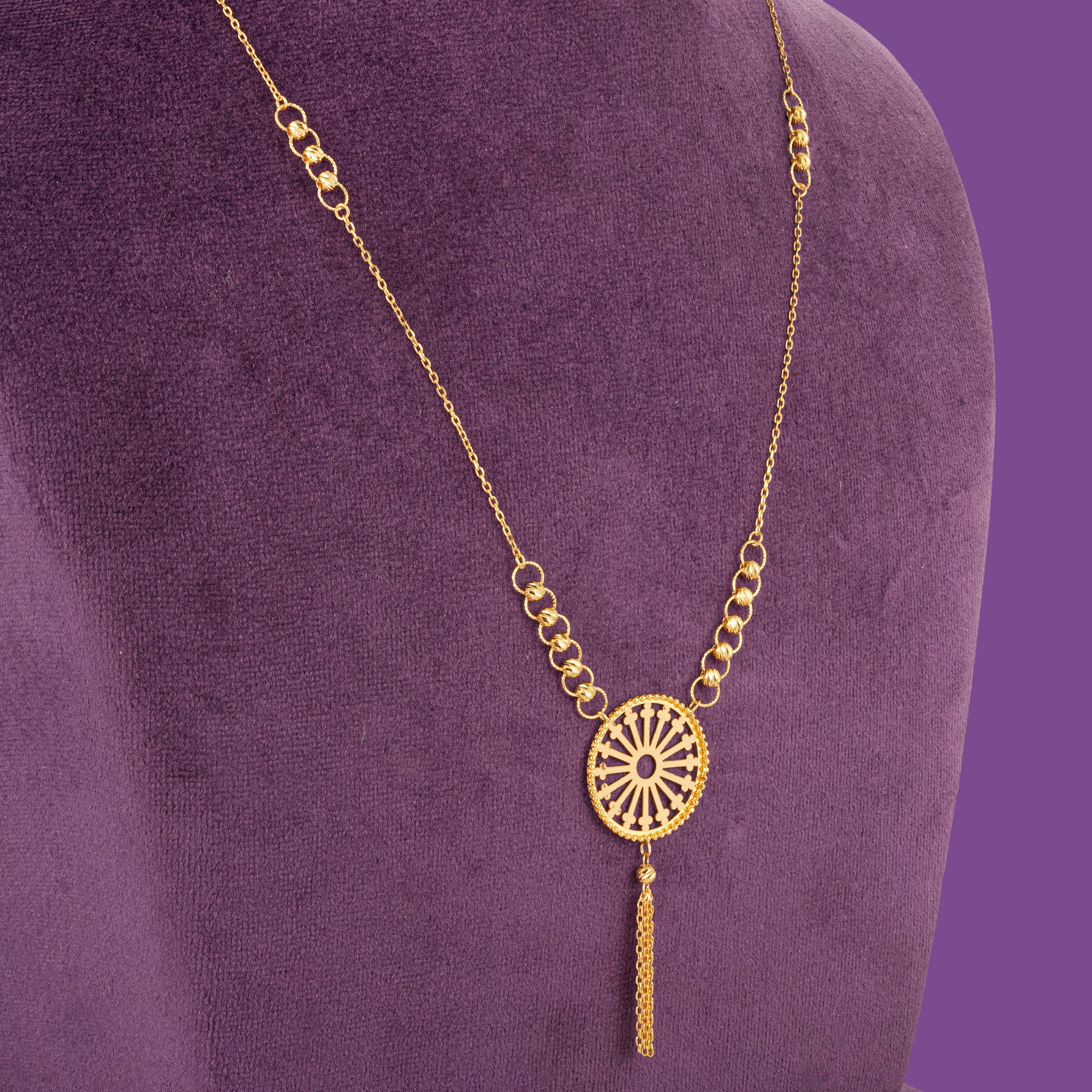 18KT gold necklace set with bracelet, ring and earrings featuring a round spoked medallion with a gold bead border.