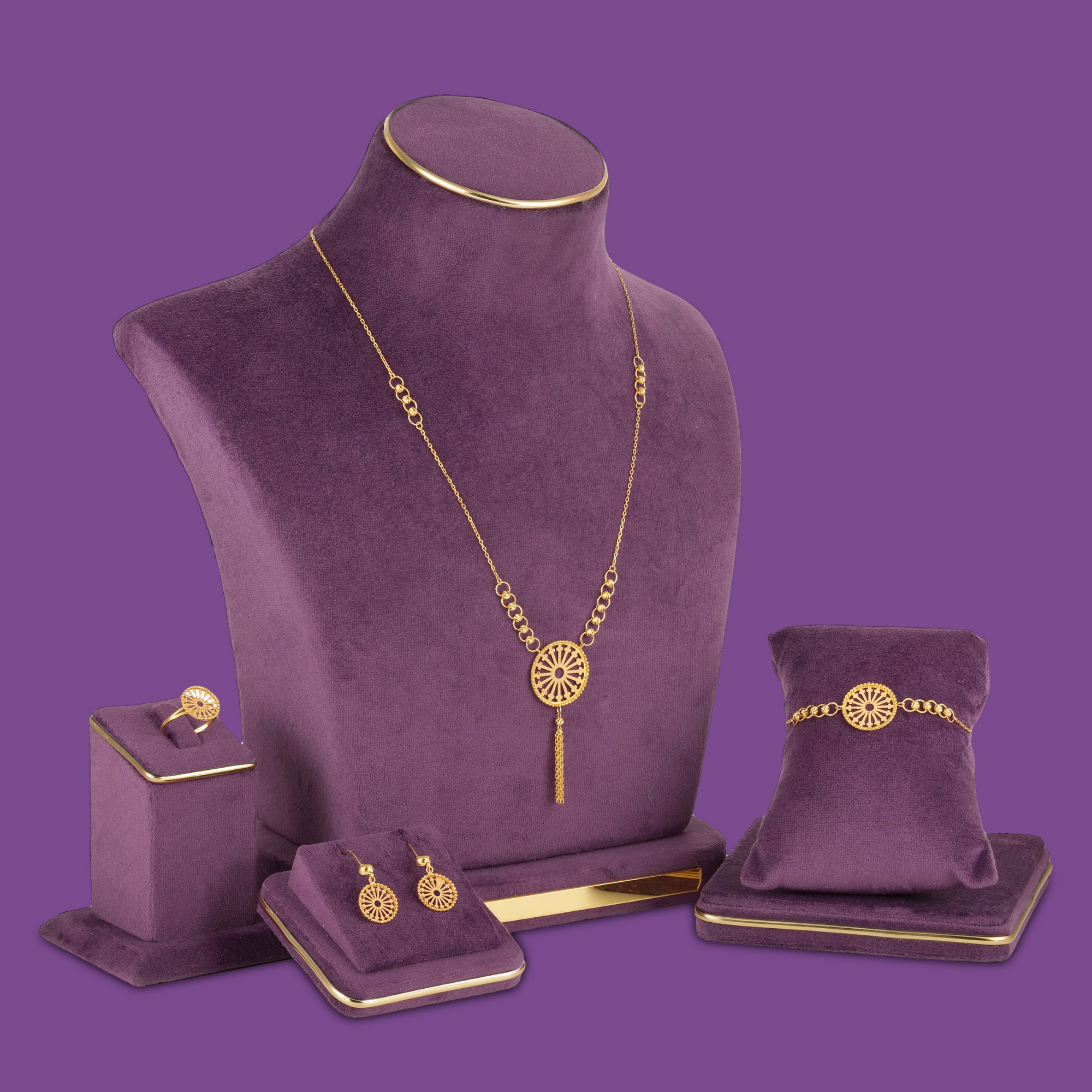 18KT gold necklace set with bracelet, ring and earrings featuring a round spoked medallion with a gold bead border.