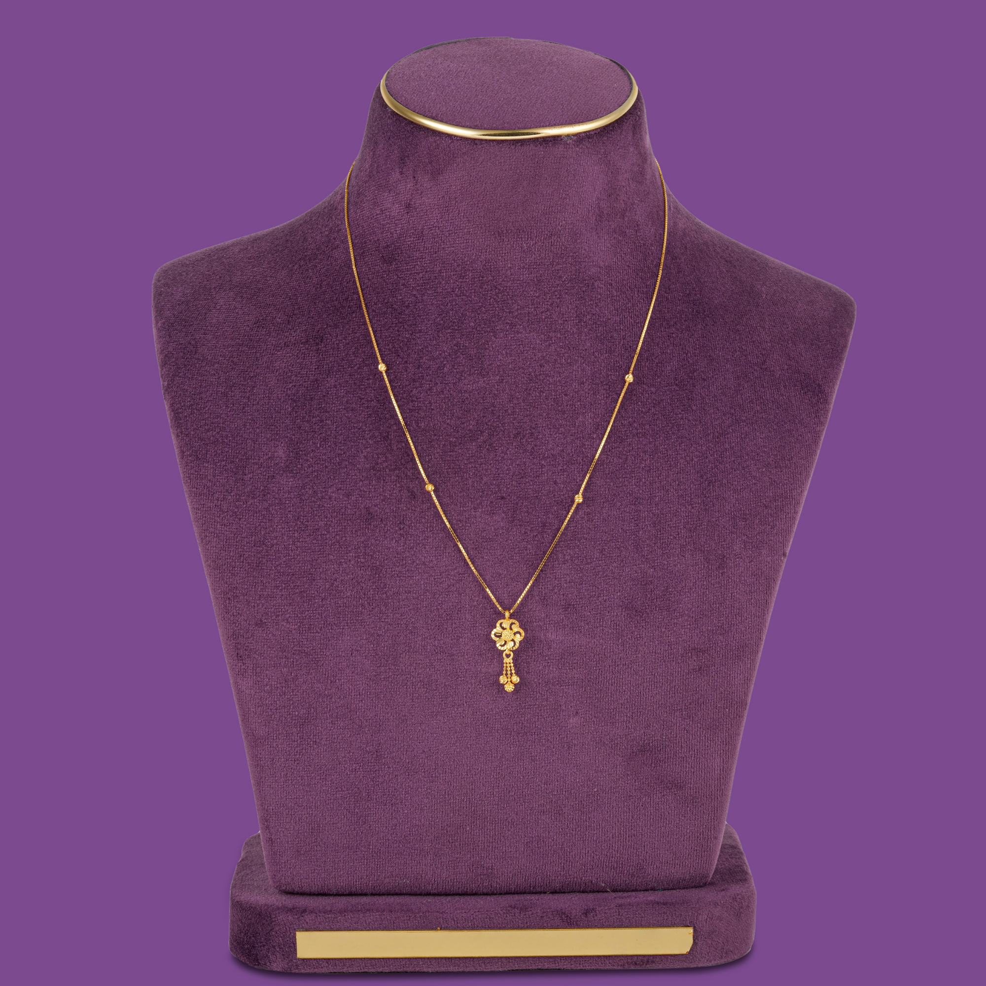 Wisp 22KT gold chain with four small beads, a flower pendant and a beaded tassel, by Taqwa Jewellers.